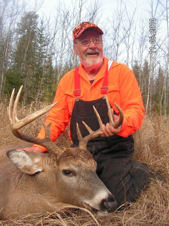 A pair of trophy-class bucks, antlers locked, battling for dominance.