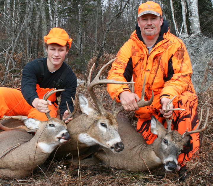 Doc's grandson Ryan, and son Ken posing with 3 nice 8 point bucks.